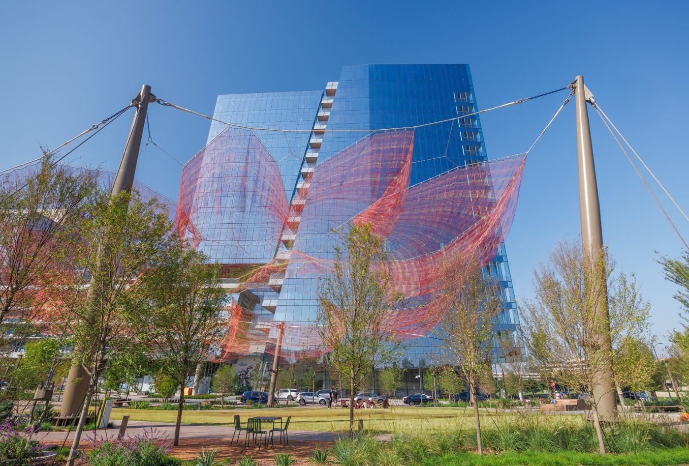 Butterfly Rest Stop, Janet Echelman’s pink and red net sculpture, floating above the Arts Plaza